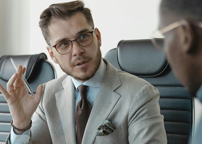 Man in professional attire discussing workplace red flags.