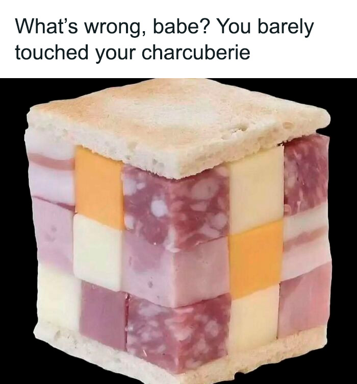 Bizarre food meme of a charcuterie cube with meats and cheeses, topped with bread.