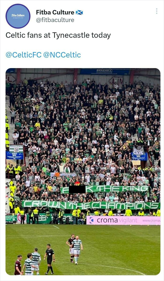 Celtic fans with humorous Scottish banner at Tynecastle stadium match.