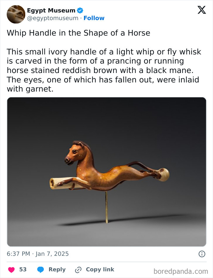 Ancient Egyptian artifact: ivory whip handle shaped like a prancing horse with garnet-inlaid eyes.