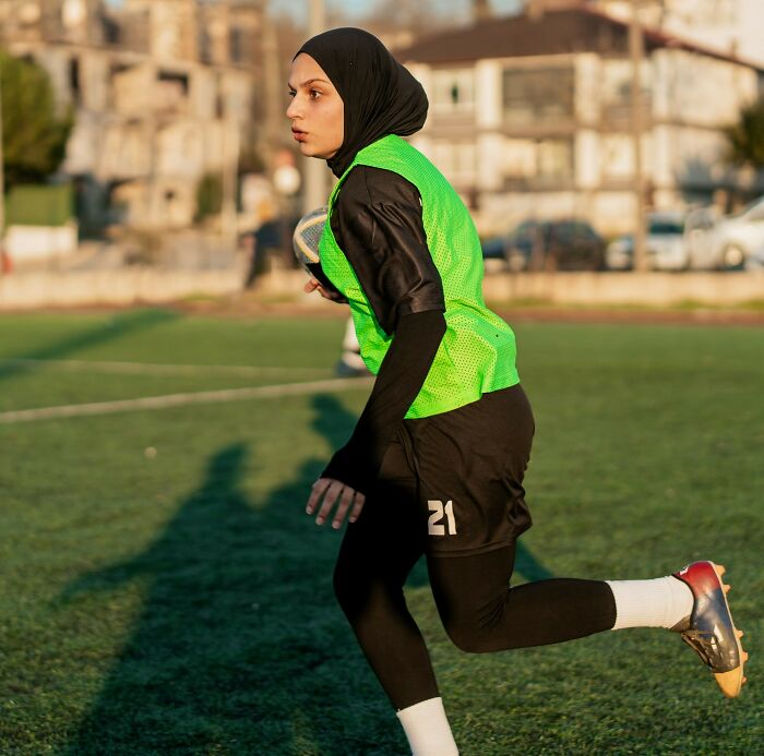 A soccer player in a green vest on the field, showcasing a news story Europeans might follow closely.