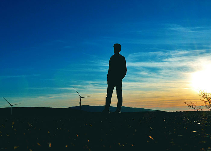 Silhouette of a person at sunset, embodying life without social media.