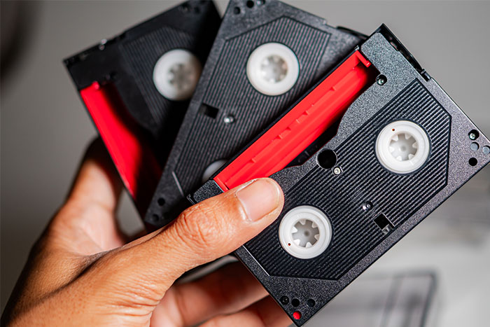 Hand holding vintage tapes, central to plans involving late mother&rsquo;s memories.