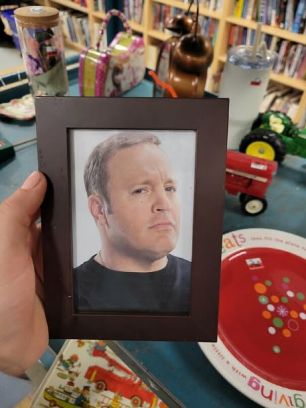 Framed photo found while thrifting, surrounded by various eclectic items on a store shelf.