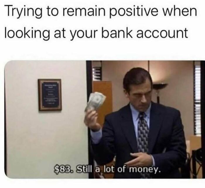 Man in suit humorously holding money, with text about remaining positive despite low bank account balance.