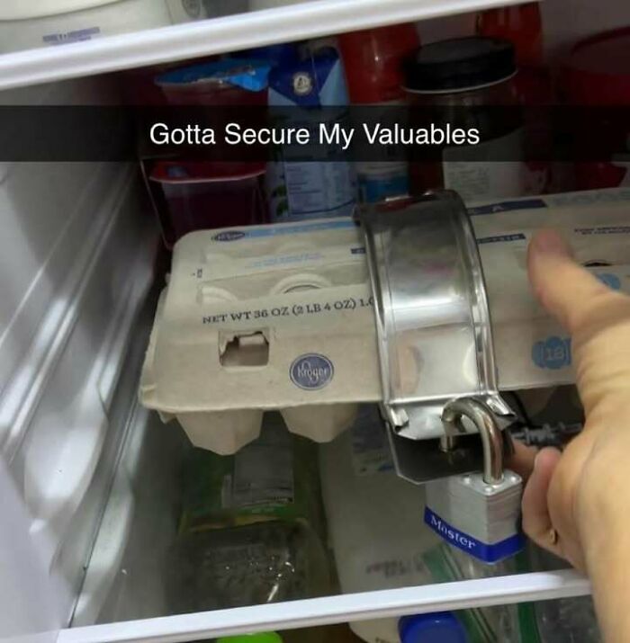 Egg carton secured with a bike lock in fridge, funny meme shared on popular Facebook page.