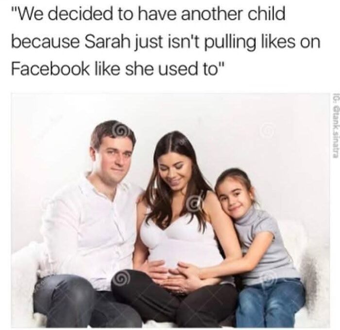 Family posing with a humorous Facebook meme about having another child for likes.
