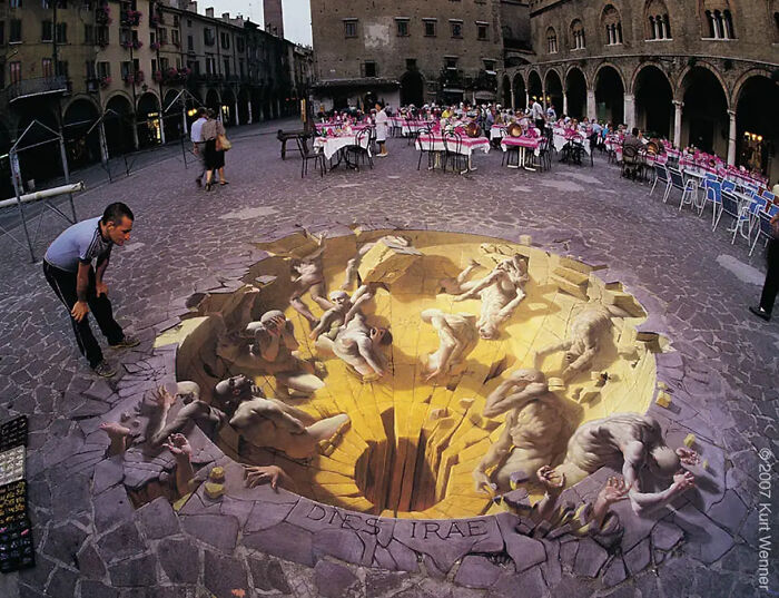 3D street art by artist on plaza, depicting creatures climbing out of a pit, creating a mind-bending optical illusion.