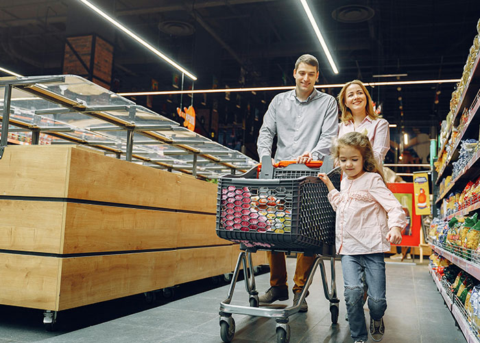 Family shopping in a grocery store, reminiscent of life without social media.