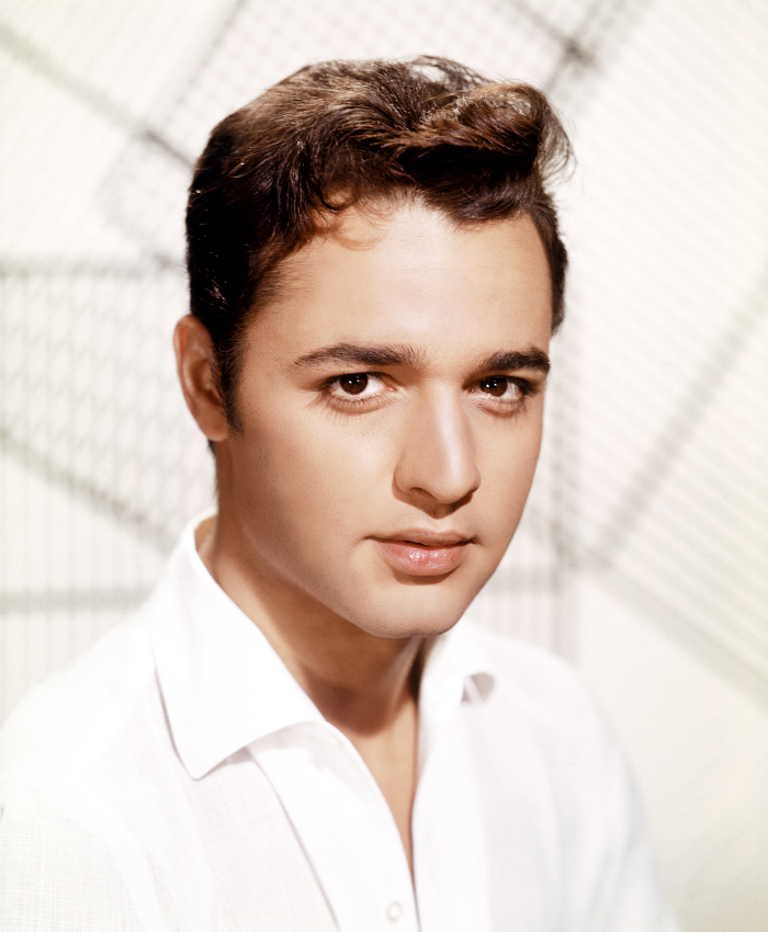 Young man in formal attire, part of infamous celebrity assassinations.