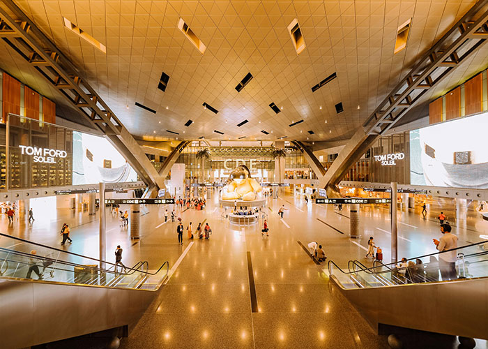 Spacious modern airport interior bustling with travelers, evoking nostalgia for life without social media.