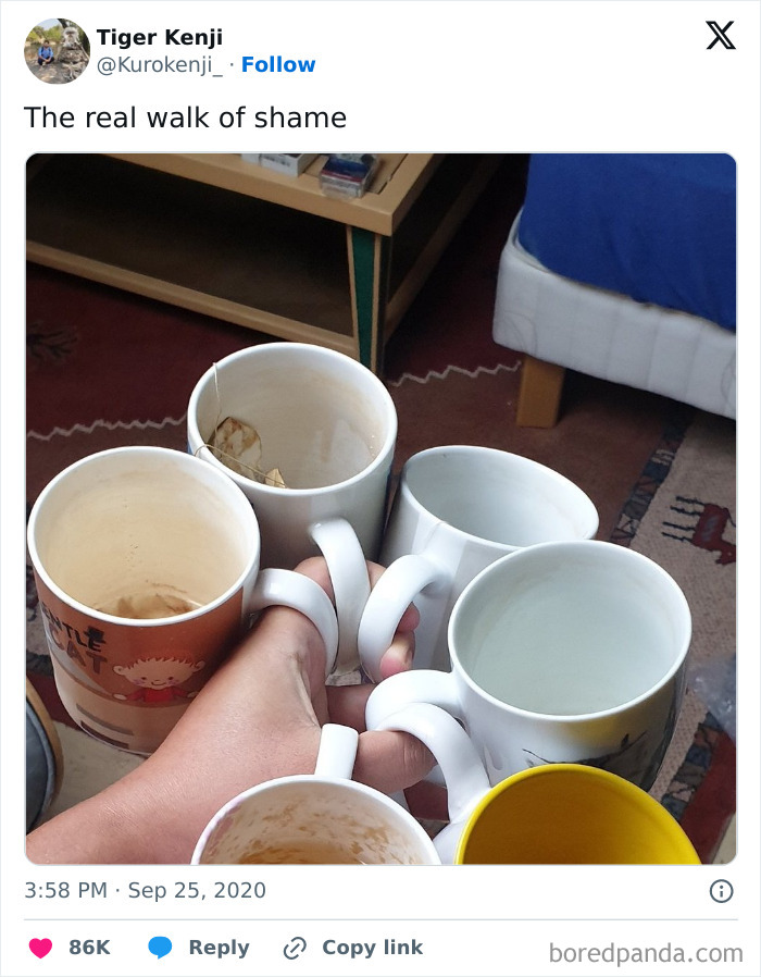 A hand carrying multiple used coffee mugs, illustrating an awkward life moment.