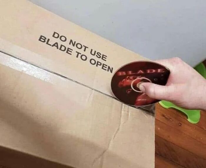 A literal meme shows a hand using a Blade DVD to open a box labeled "Do not use blade to open."