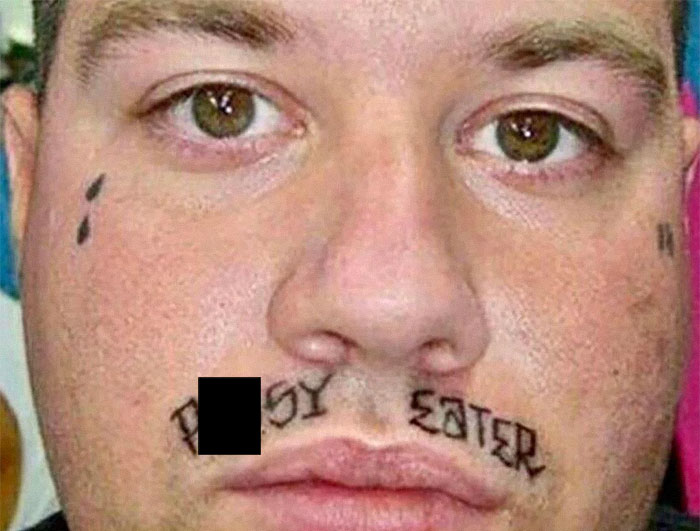 Man with facial tattoos, including a teardrop and provocative words, illustrating tattoos that people find unattractive.
