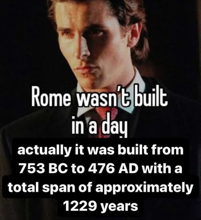 Man in suit with a literal meme about Rome's construction timeline, showcasing humorous text and historical dates.