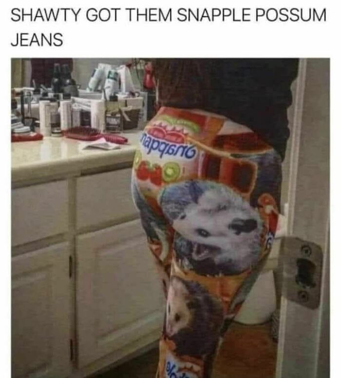 Person in Snapple-themed leggings with possum images, standing in a bathroom.