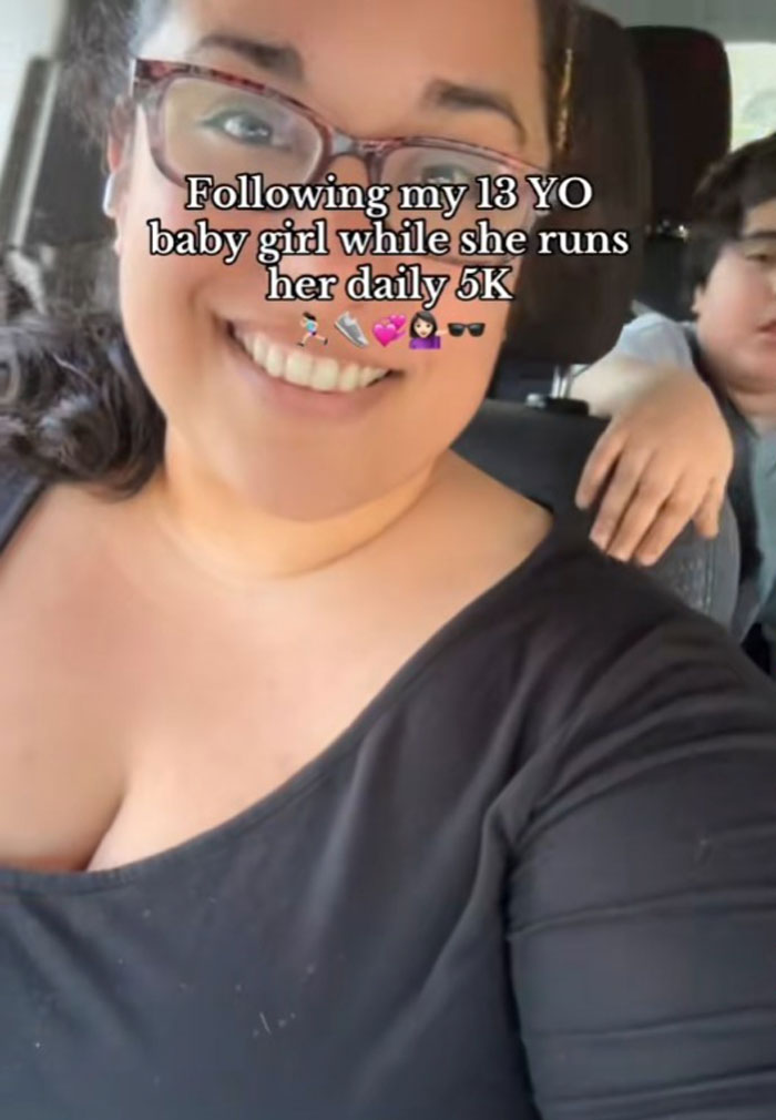 Mom supporting daughter during her 5K run, smiling in a car selfie.