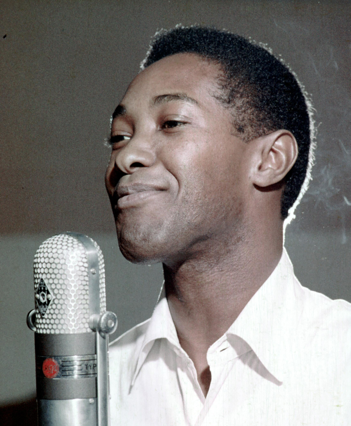 Singer at microphone, highlighting infamous celebrity assassinations in Hollywood.