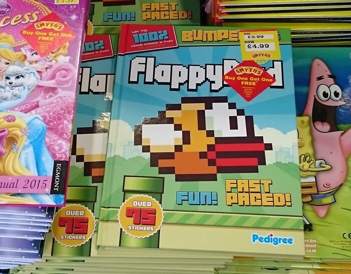 Flappy Bird game book on display with promotional stickers, surrounded by other colorful children's books.