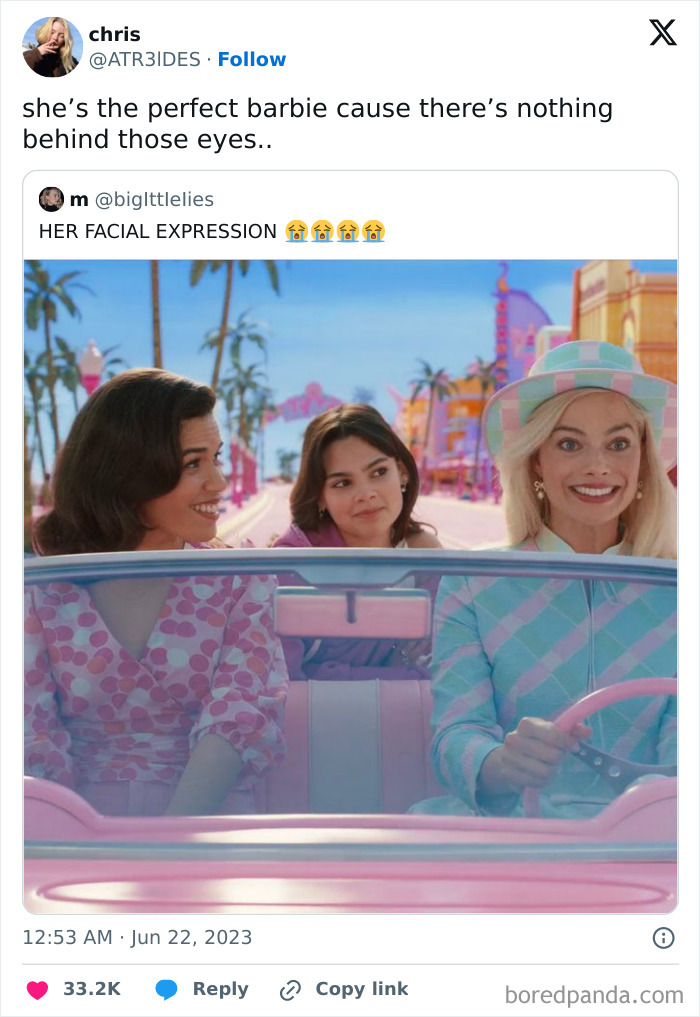 Three women in a pink convertible, one looking ahead expressionless.