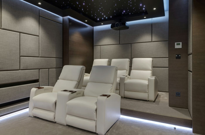 Home theater with plush recliners and ambient lighting, typical in American homes.