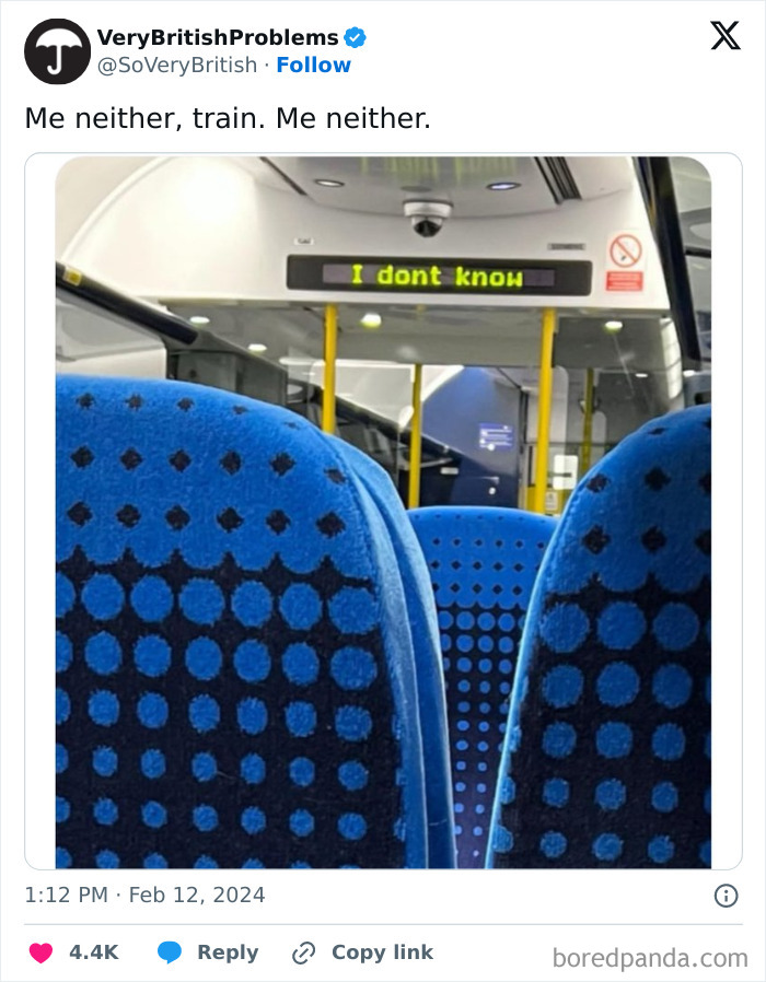 Train interior with blue seats and a sign reading "I don't know," highlighting British humor.