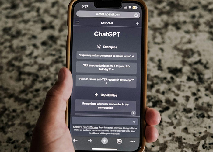 Hand holding a smartphone displaying the ChatGPT interface, focusing on beauty tips.