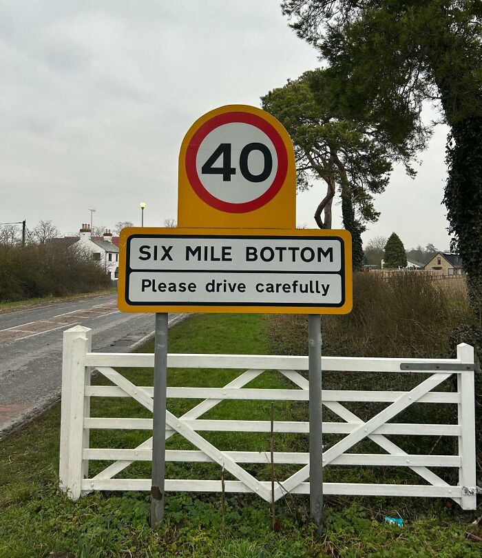 Road sign for Six Mile Bottom village, highlighting British humorous place names.