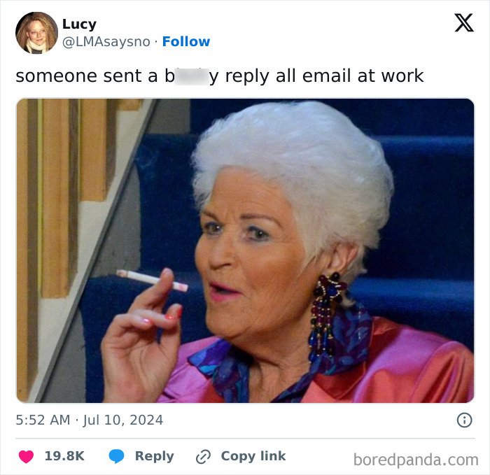 A woman with white hair reacts humorously to work-email-jokes, holding a cigarette, dressed in colorful attire.