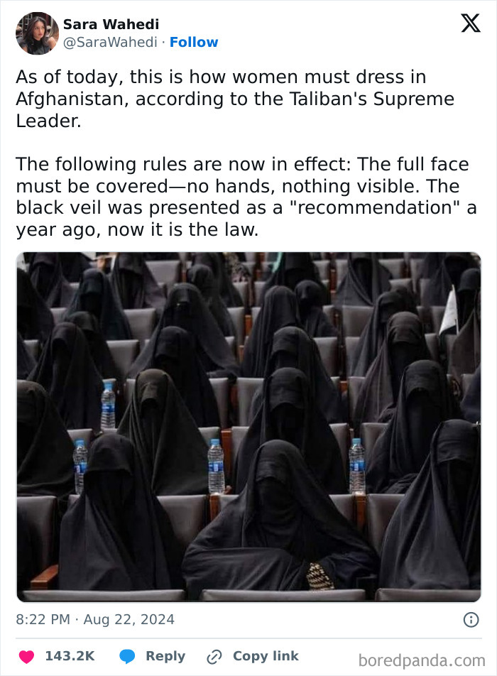 Women dressed in black veils in Afghanistan, adhering to the new Taliban dress codes.