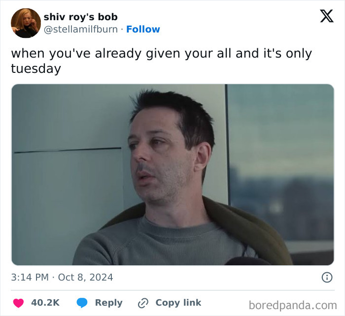 Man looking exhausted in office, capturing the humor of work tweets.