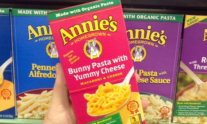 Box of Annie's Bunny Pasta with Yummy Cheese held in hand, featuring easy lazy meal option.