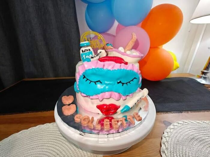 Creative baking fail cake with colorful decorations and balloons, humorously depicting a spa theme.