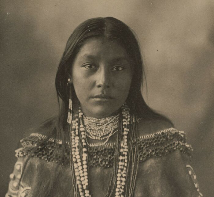 Woman from history in traditional attire, showcasing cultural heritage from the dark side of history.