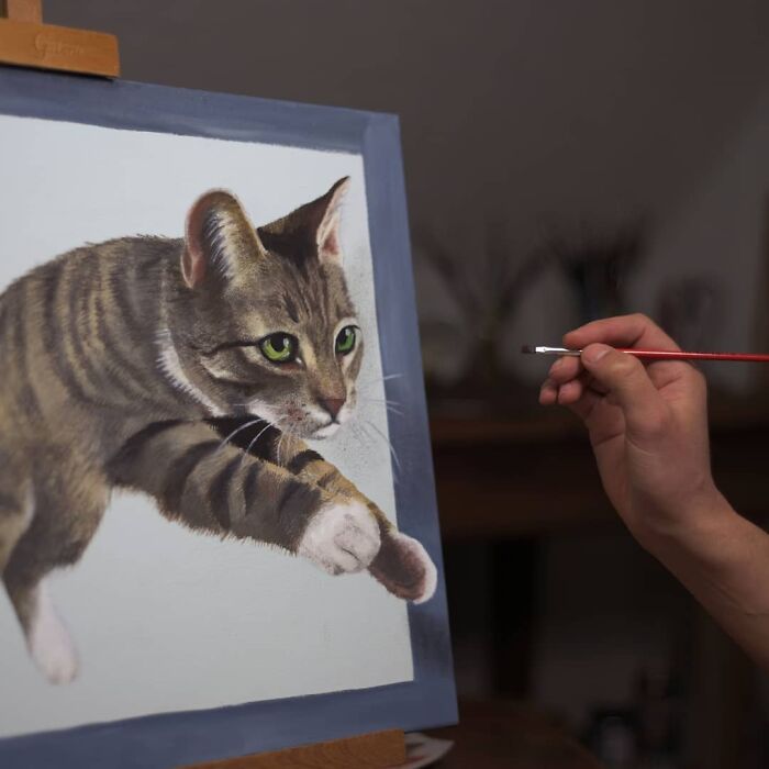 A professional artist painting a 3D image of a cat, demonstrating incredible drawing skills.
