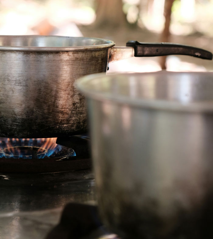 A metal cooking pot on a stove, potential home hiding spot.