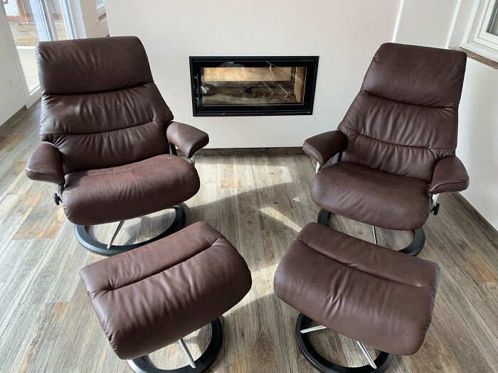 Two brown recliner chairs with ottomans in a room, showcasing cozy "old people" habits.