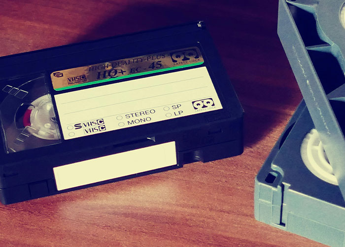 VHS tapes on a wooden table, evoking nostalgia for life without social media.