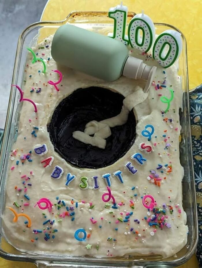 Decoratively failed cake with icing, sprinkles, candles, and a lotion bottle topper, showcasing a baking fail.