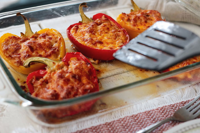 Stuffed bell peppers in a glass dish, showcasing a classic old-school delicacy.