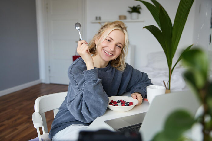 Person enjoying breakfast with berries, embracing “old people” habits at home.