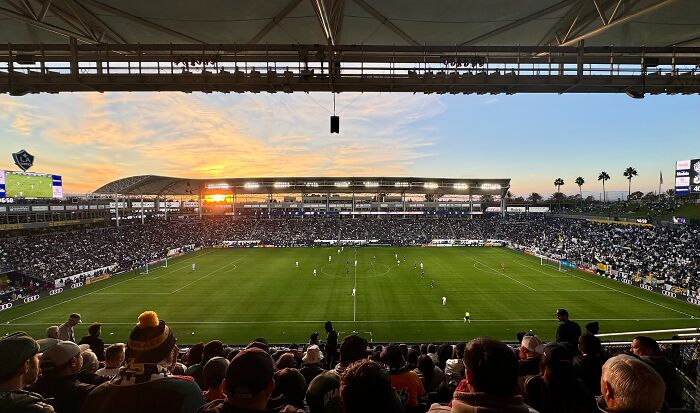 Soccer stadium filled with fans at sunset, showcasing one of the iconic cathedrals of soccer where legends are born.