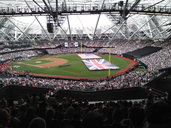 Large crowd fills a stadium with a baseball field, showcasing one of the iconic cathedrals of soccer where legends are born.