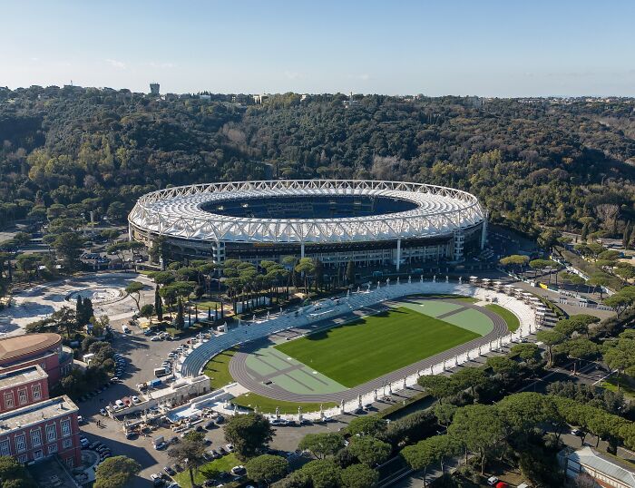Aerial view of a famous soccer stadium surrounded by trees, one of the iconic cathedrals of soccer tradition.