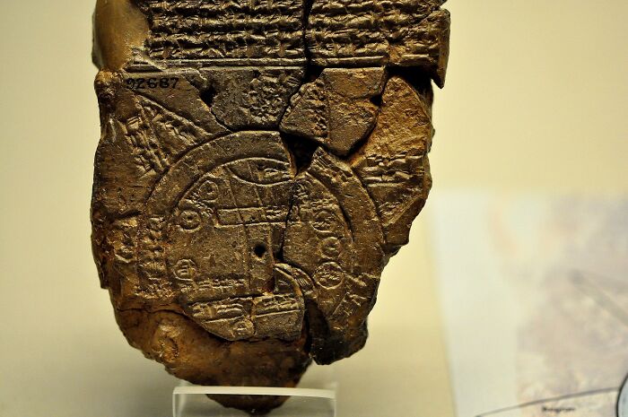 Ancient artifact featuring a historical map etched into a clay tablet, offering insights into past cartography.