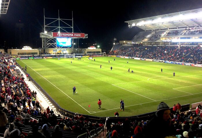 Soccer stadium filled with fans during a night match, showcasing one of the iconic cathedrals of soccer.