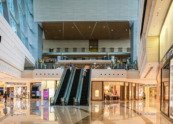 Modern shopping mall with escalators, recalling Gen X memories of life without social media.