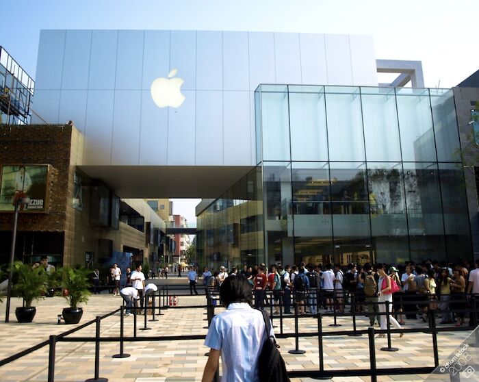 Apple store with a crowd gathered outside, illustrating easy ways people have made money.