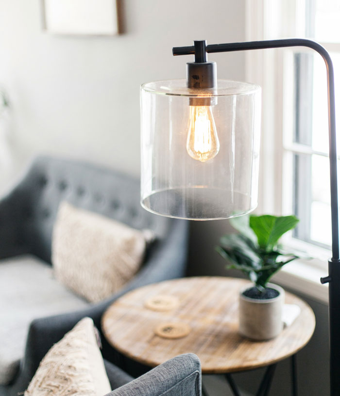 Cozy living room with a hanging glass lamp, ideal for hiding small things at home.