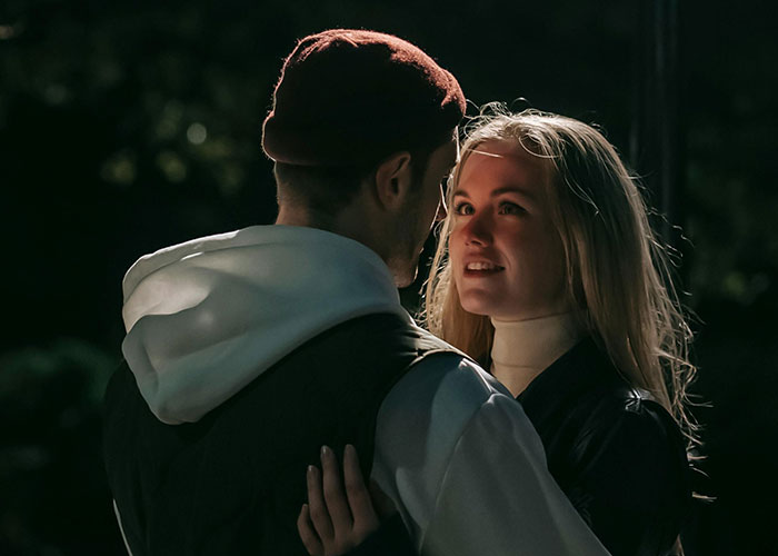 Couple shares an intimate moment outdoors, symbolizing supportive reactions to coming out of the closet.